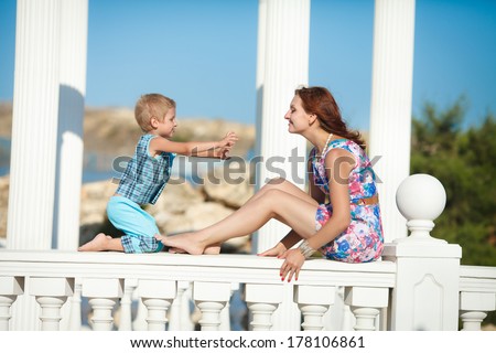 Mother and child playing in park lifestyle, happy family vacation. Young woman and son resting outdoor. series