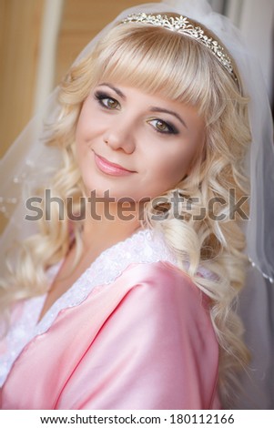 Beautiful Bride wedding makeup and hairstyle at bridal morning. Happy woman at wedding day have final preparation for marriage. Happy newlywed. Marriage. Wedding day moments. Bride makeup. Series.