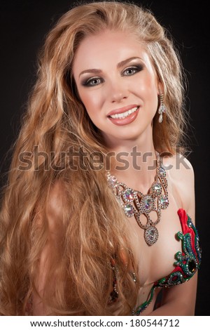 Beauty Portrait Woman, Blonde girl with long curly hair,Glamour Makeup. Gold Jewelry. Hairstyle. Luxury lady. studio, isolated on black. Series.