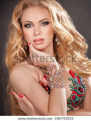 Beauty Portrait Woman jewelry, Blonde girl with long curly hair,Glamour Makeup. Gold Jewelry. Hairstyle. Luxury lady. Oriental bellydancer. studio, isolated on black. Series.