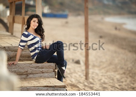 Beautiful happy woman outdoor portrait lifestyle, attractive female walking at beach enjoying sun. spring summer time series.