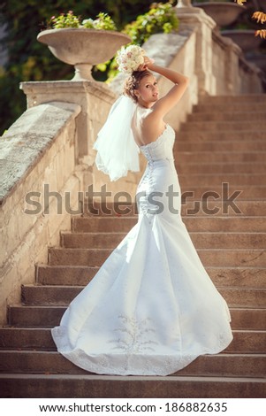 Beautiful Bride in wedding day outdoors. Newlywed woman on nature. Young woman in wedding dress outdoors.