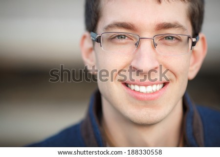 Smiling man portrait student of college, handsome male student in glasses. smart successful man portrait outdoors. business guy face. sunset.