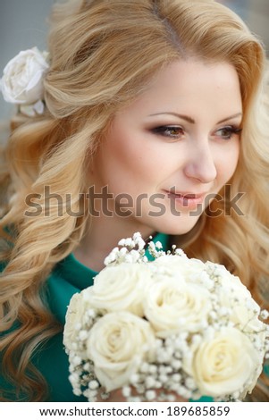 Beautiful Bride with wedding makeup and hairstyle. Wedding day woman with marriage flowers. Happy blonde bride outdoor. Sunset.