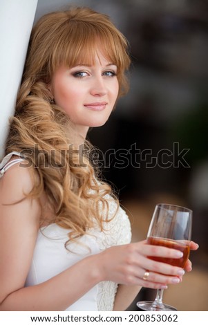 Beautiful young woman in restaurant, girl drink juice in cafe.