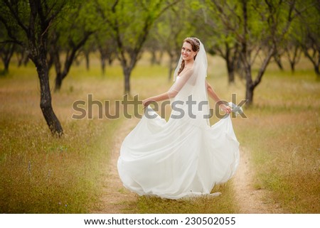 Beautiful young bride outdoors. Happy Bride waiting groom. Marriage Wedding day moment. Bride portrait