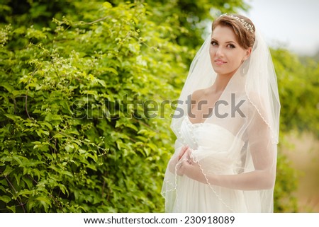 Beautiful young bride outdoors. Happy Bride waiting groom. Marriage Wedding day moment. Bride portrait soft light and soft focus. series