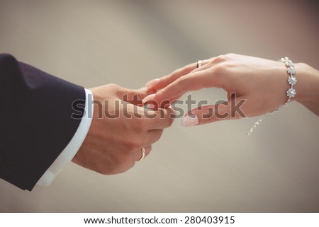 Wedding couple holding hands on sunset. Wedding rings. Man giving an engagement ring to his girlfriend