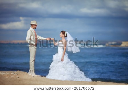 Bride and groom wedding portrait outdoors newlyweds loving couple sea tropical marriage bridal flowers, kissing man and woman at wedding day, selective focus, series