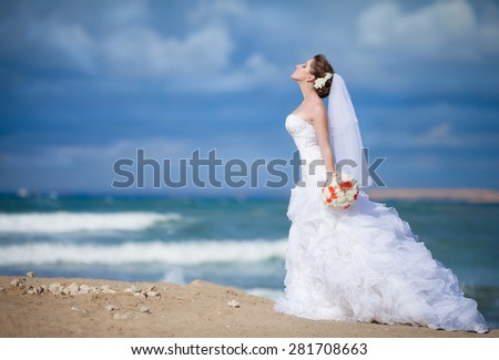 Beautiful young bride outdoors at sea. Happy Bride smiling tropical wedding. Marriage Wedding day moment. Bride portrait
