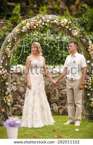 Bride and groom wedding portrait outdoors newlyweds loving couple marriage ceremony bridal flowers, kissing man and woman at wedding day, selective soft focus, series.