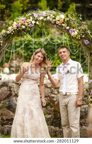 Bride and groom wedding portrait outdoors newlyweds loving couple marriage ceremony bridal flowers, kissing man and woman at wedding day, selective soft focus, series.