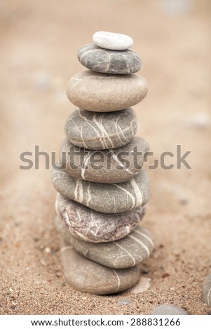 Zen stones garden, Spa stones treatment scene, zen like concepts, Stones pyramid on sand symbolizing zen, harmony, balance, series