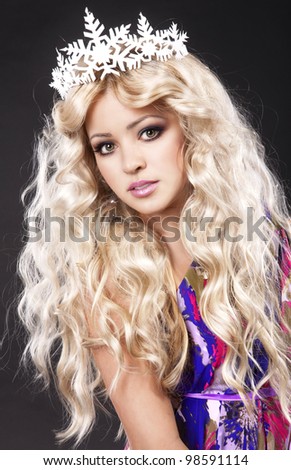 Beautiful young girl beauty contest winner with long healthy glossy hair with silver tiara in colorful dress. Fashion shot spring - summer. Princess and mermaid style.