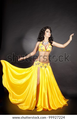 beautiful slim woman belly dancer sexy arabian turkish oriental professional artist in carnival shining costume with long healthy glossy hair. exotic star of bellydance. spring-summer