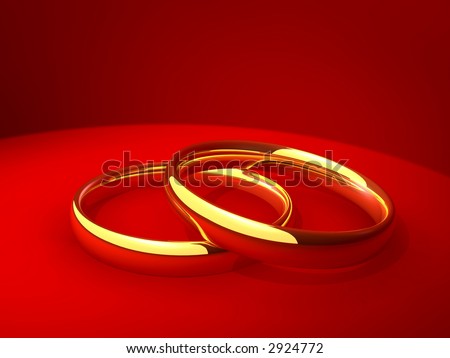 stock photo Pair of gold wedding rings laying on a red background