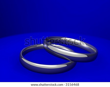 stock photo silver wedding or engagement rings on blue background