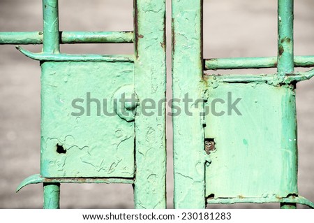 Obsolete light green painted locks of metal patio doors