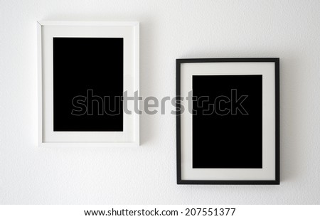 empty black and white picture frames on the wall