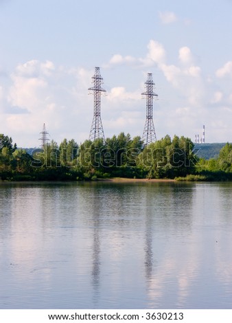 In a photo the wide river through which there there takes place the high-voltage line providing with an electricity a large megacity