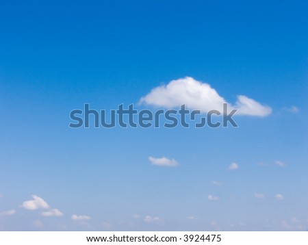 The blue sky with several small clouds. A background on a theme about a fine summer weather.