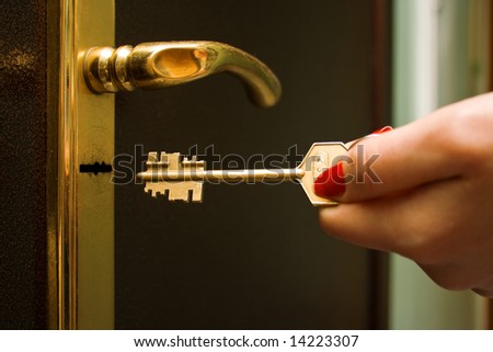 The female hand, locking a key an iron door