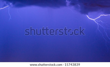 Photo of a lightning during a thunder-storm on a background of the dark dark blue sky