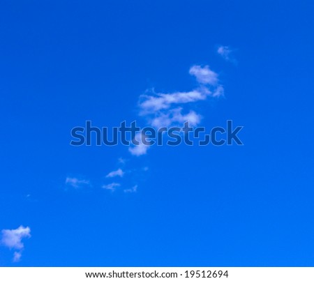 The blue sky with several small clouds. A background on a theme about a fine summer weather.