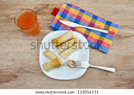delicious breakfast: pancakes with red salt fish and soft cheese, and fruit juice