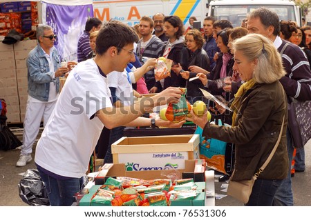 ROME, ITALY - MAY 1: Volunteers hand out snacks to people attending the beatification of Pope John Paul II in Rome, Italy on May 1, 2011.