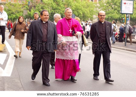 ROME, ITALY - MAY 1: The three Catholic priests marching among people attending the beatification of Pope John Paul II in Rome, Italy on May 1, 2011.
