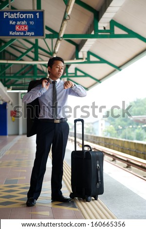 Young business man waiting train
