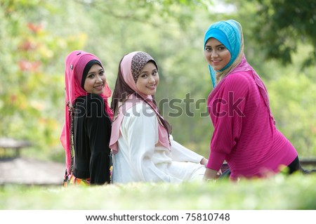 young muslim woman in head scarf meet friends in the park