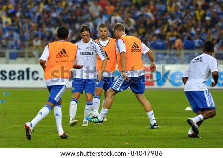 KUALA LUMPUR, July 21 : Chelsea\'s Fernando Torres (in white) and team mate warm-up during a preseason match agains Malaysia on July 21, 2011 in Kuala Lumpur, Malaysia. Chelsea won 1-0