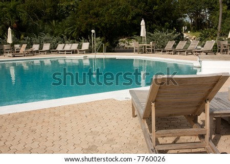 swimming pool with loungers with no people in sight