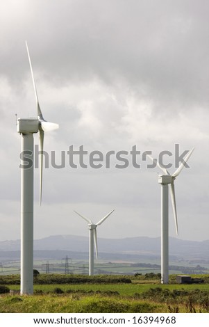 wind turbine electricity generator towers in summer