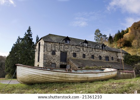 open boat in front of old warehouse on an autumn day
