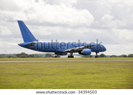 large blue passenger jet aircraft on runway for take off