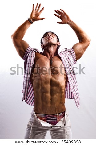 Bodybuilder man in a plaid shirt in the studio