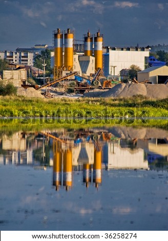 factory on concrete manufacture is reflected in the river