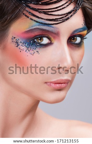 Beautiful girl with color makeup