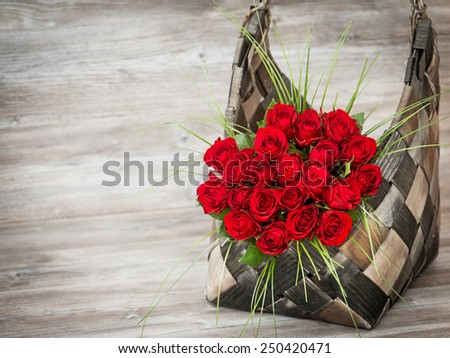 Beautiful bouquet of red roses in a basket