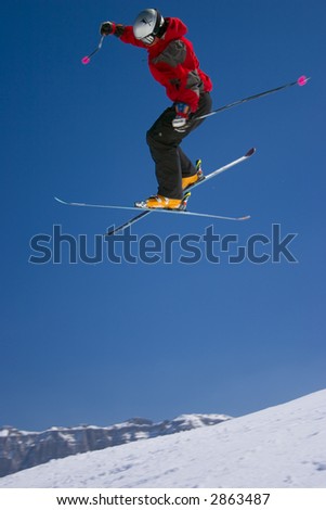 Extreme ski jumper jumping high at full speed - winter mountains action scene
