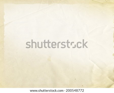 Yellowed sheet of paper, faded background.