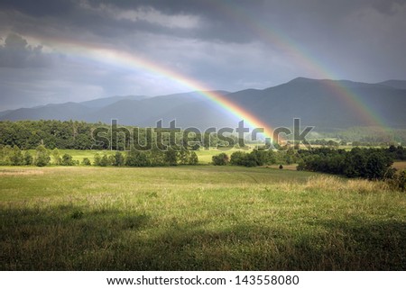 This is an image of a dual rainbow over the Cades Cove section of the Great Smoky Mountain National Park.
