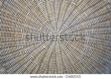 A circular wicker design from the top of a wicker table.