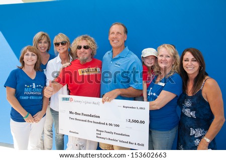ROSEVILLE, CA - September 5: Sammy Hagar and wife Kari make a donation to the Me One Foundation at Roseville\'s Town Sqaure in Roseville, California on September 5, 2013