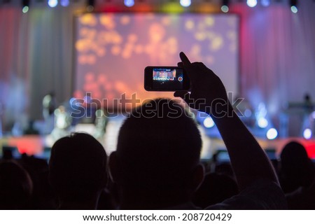 LINCOLN, CA - August 1: Fan records boy band New Edition on a smartphone at Thunder Valley Casino Resort in Lincoln, California on August 1, 2014