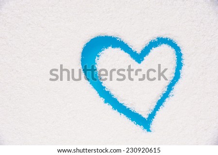 Heart shape painted on frozen window