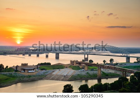 Sunset over the Mississippi River, Hernando de Soto Bridge, and Mud Island River Park in Memphis, Tennessee, USA.